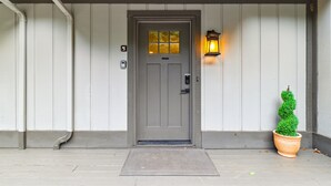 A gray door with a window, a mailbox, and a potted plant on the porch. - Quiet Mountain Home with Fireplace, A+ location! (Banner Elk)