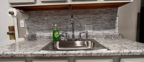 Fridge, microwave, coffee/tea maker, cookware/dishes/utensils