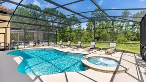 A covered outdoor swimming pool with lounge chairs and a hot tub. - Contemporary 6 Bed 6 Bath Luxury Villa at Watersong (Davenport)