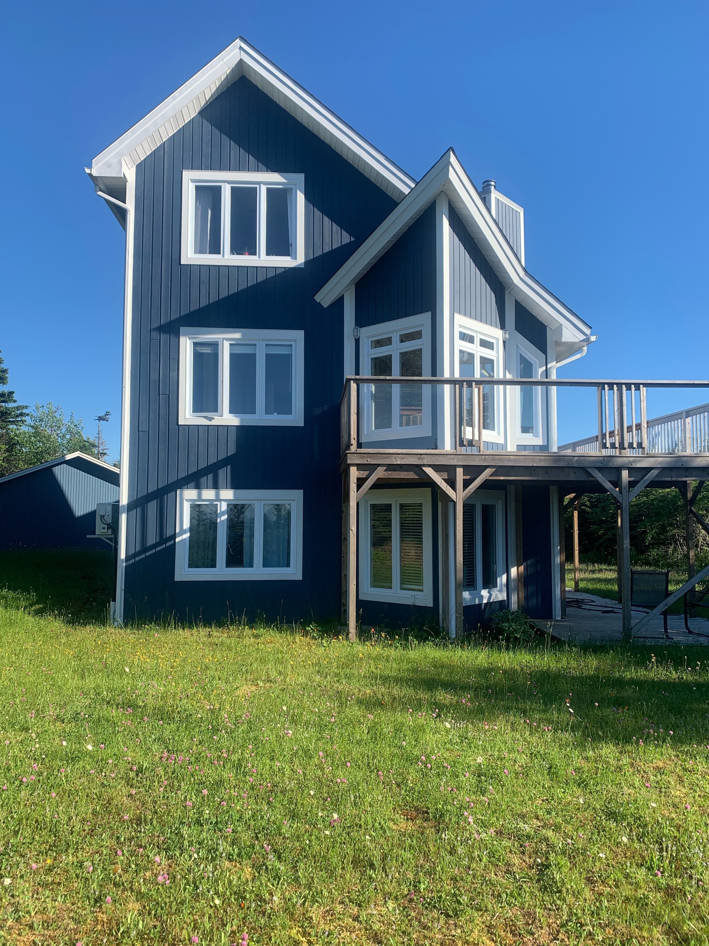 A two-story house with a balcony and a covered porch.