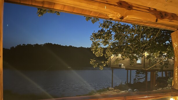 A wooden cabin with a view of a lake at dusk. - "Eagle's Nest" Tree House #5 w/ 2-person hot tub (Potosi)