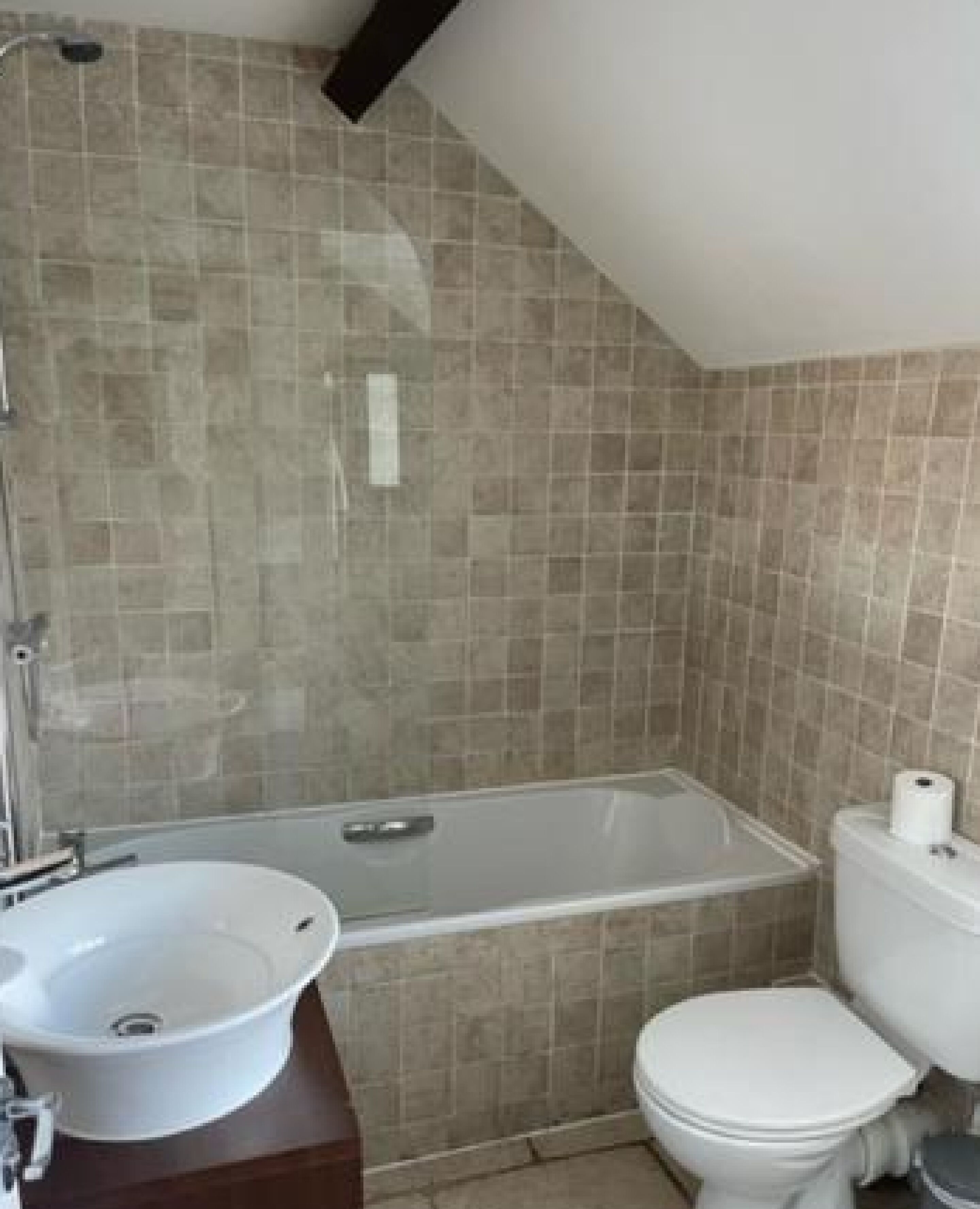 A bathroom with a bathtub, a sink, and a toilet.