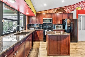 Enjoy cooking in this well-equipped kitchen with a large island, sink, and ample counter space.