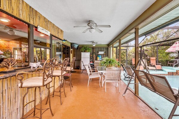 Relax by the pool with comfortable seating and a refreshing view.