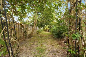 Stroll through the serene garden, surrounded by lush greenery and a natural setting.