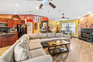 Relax in this inviting space with a comfortable sofa, kitchen, and dining area, perfect for evening gatherings and meals.