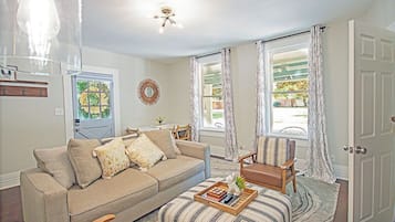 Relax in this inviting living room with a sofa, coffee table, and ottoman.