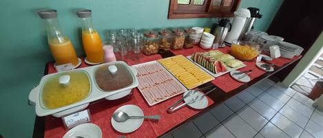 A breakfast buffet with various food items and beverages.