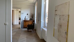 A hallway with a wooden floor, a radiator, and a chair. - Large Burgundy gîte near Chablis - Auxerre ideal for families & reunions (Valravillon)