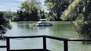 A lake with boats, surrounded by dense trees.