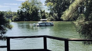 A lake with boats, surrounded by dense trees.