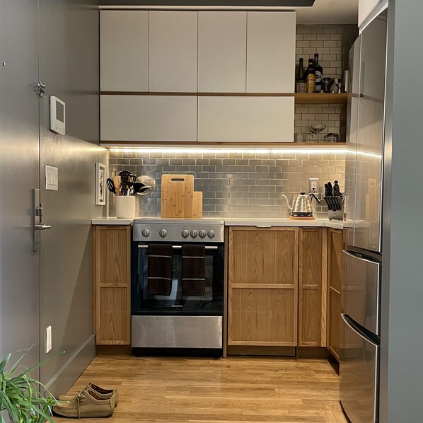 Efficient kitchen with stainless steel oven, dishwasher, and ample storage.
