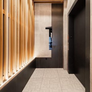 Elevator with a minimalist design, featuring a dark finish and metallic handle.
