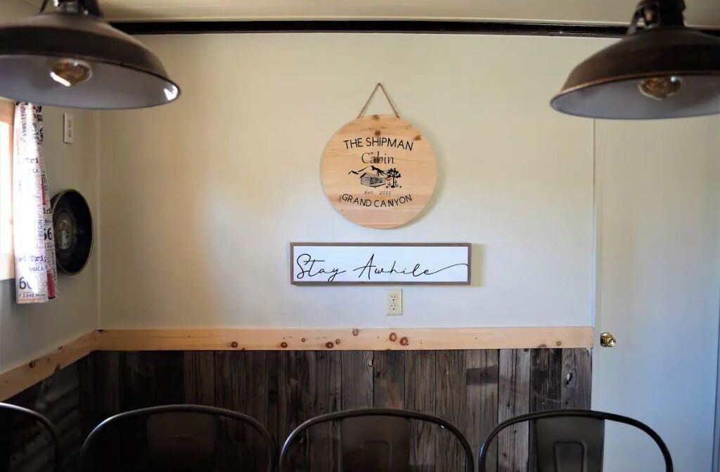 A wooden wall with a circular sign and a rectangular sign.
