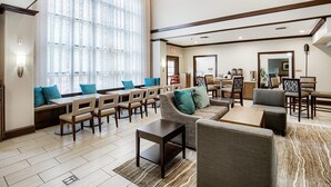 A hotel lobby with seating areas, a coffee station, and a dining area. - Equipped Studio | Top Location, Gym Access + Pool (Gulf Shores)