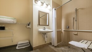 A bathroom with a sink, mirror, shower, and towel rack. - Equipped Studio | Top Location, Gym Access + Pool (Gulf Shores)