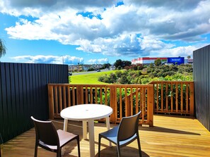 Enjoy an outdoor space with a round table and two chairs, offering a view of the surrounding neighborhood.