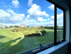 Guests can enjoy a serene view of the well-manicured lawn and surrounding trees from the comfort of their room.