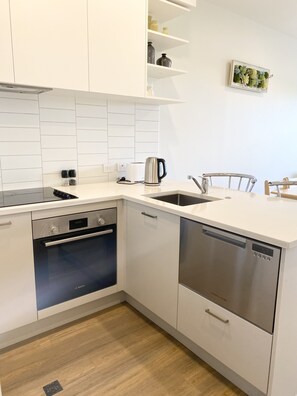 Enjoy cooking in this well-equipped kitchen with a Bosch dishwasher, compact oven, and sink.