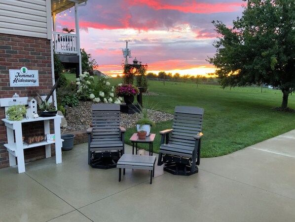 A patio with two chairs and a table, a brick wall, and a sign reading 'Jemma's Hideaway'. - Jemma’s Hideaway in Amish Country (Dundee)