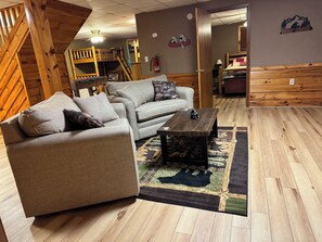 A cozy living room with a sofa, coffee table, and a rug.
