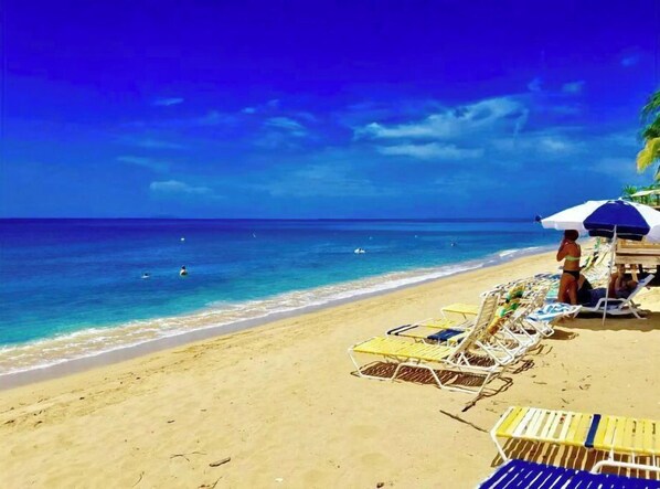 On the beach, sun loungers, beach towels
