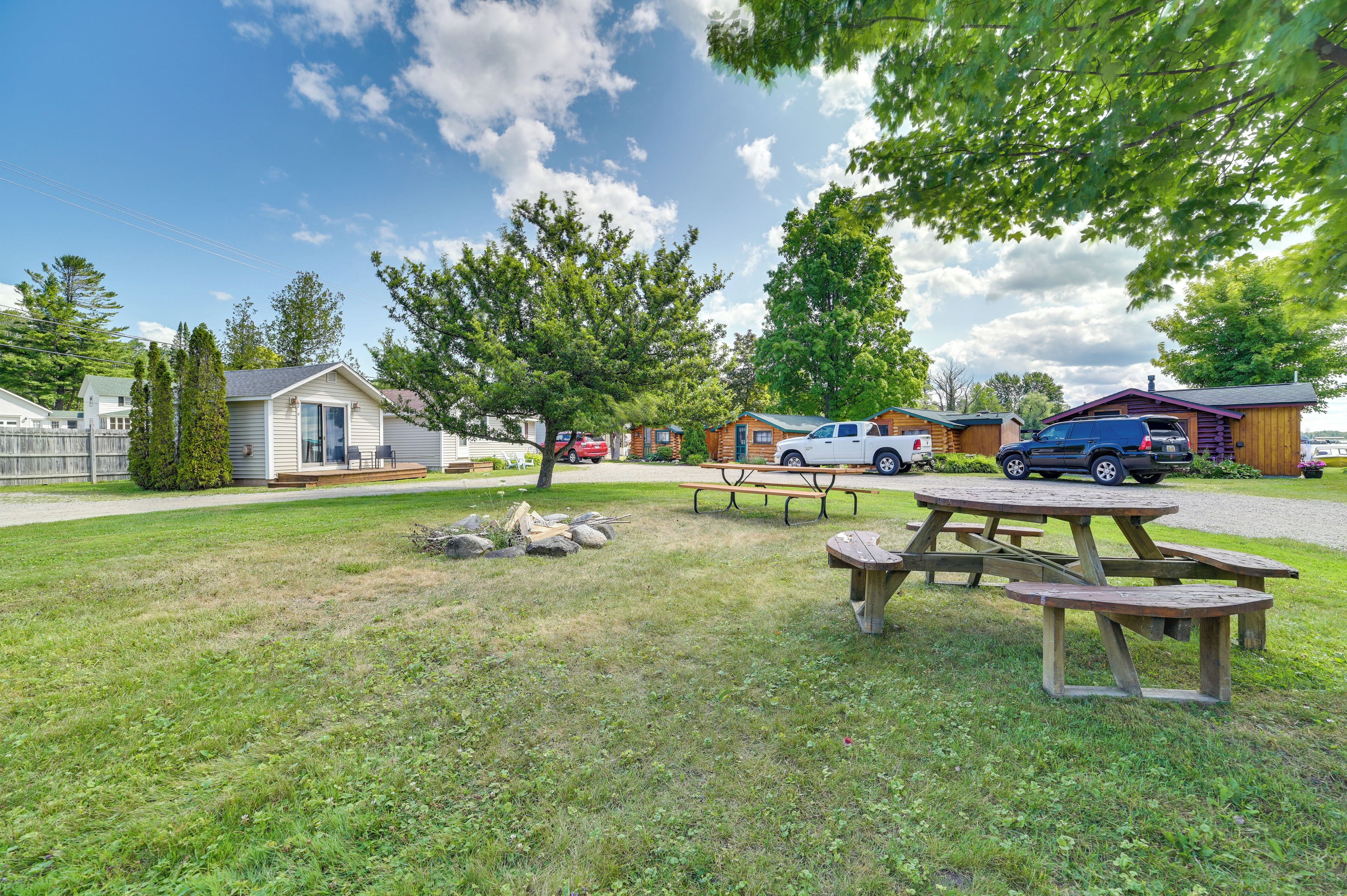 A campground with picnic tables, RVs, and cabins.
