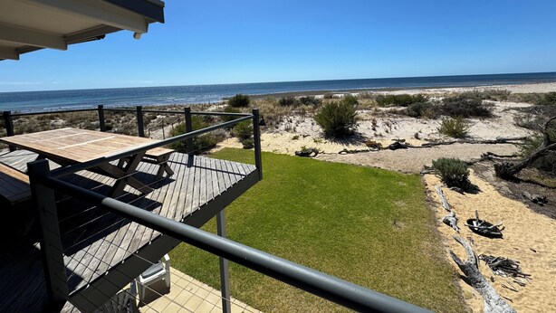 A wooden deck with a view of the beach and ocean. - Normanville Beach House - Wake up to the sound of the ocean and bird life. (Normanville)