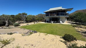 A modern two-story building with a flat roof and large windows. - Normanville Beach House - Wake up to the sound of the ocean and bird life. (Normanville)