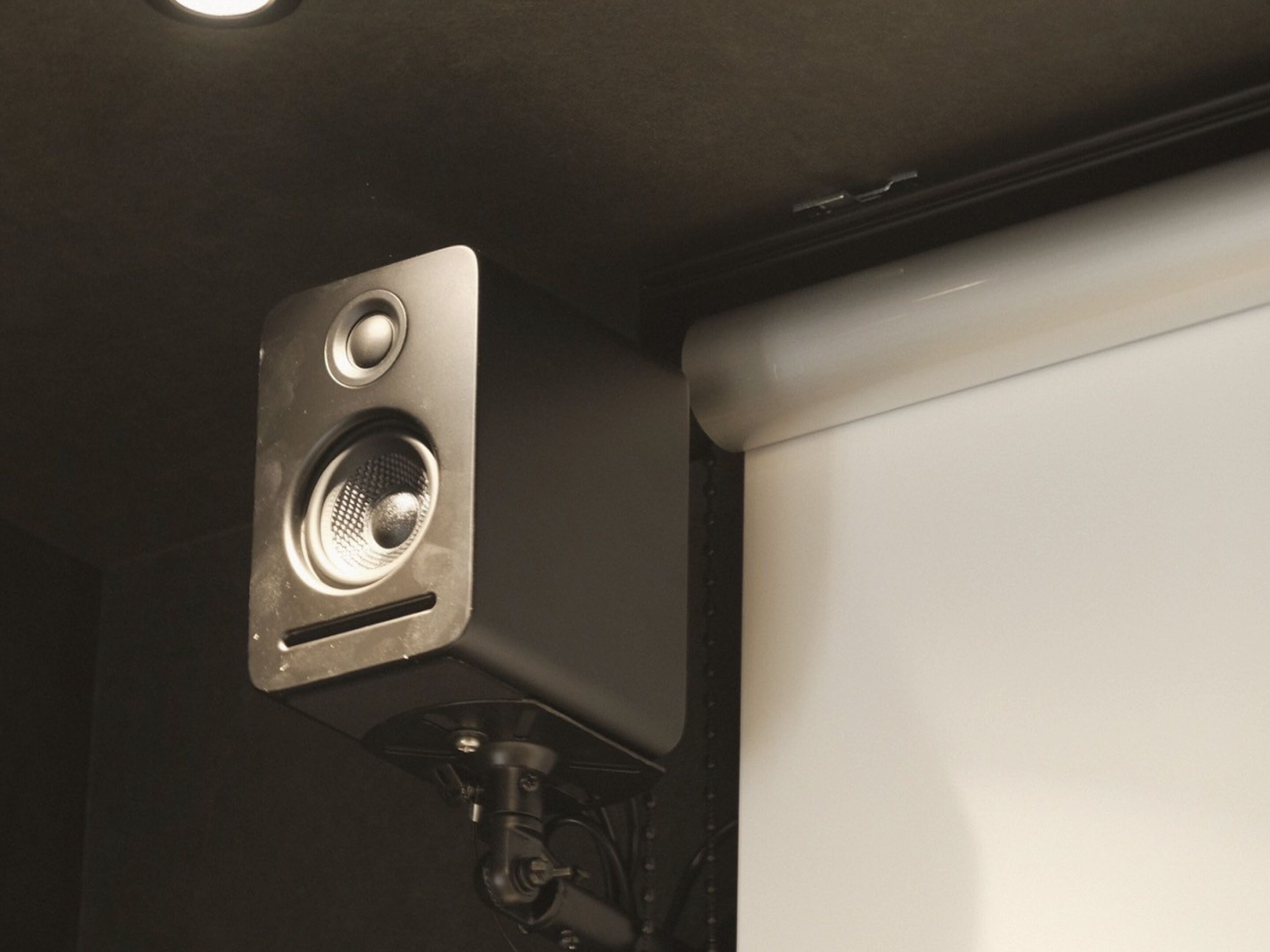 A wall-mounted speaker with a control panel.