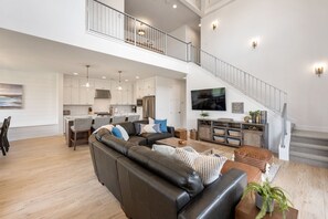 Relax in a spacious living area with a large sofa and coffee table, and enjoy a kitchen with stainless steel appliances.