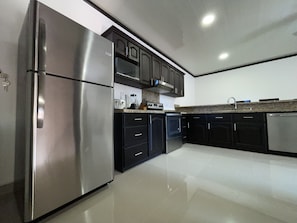 Deluxe Condo | Private kitchen | Full-sized fridge, microwave, oven, stovetop
