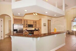 Enjoy cooking in this well-equipped kitchen with a central island, modern appliances, and ample countertop space.