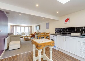 A modern apartment with a living room, dining area, and kitchen. - Traditional and stylish converted two storey historic coach house. (Calthwaite, Nr Penrith)