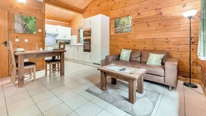 Un interior de madera con comedor, cocina y sala de estar.