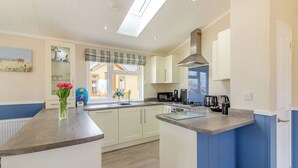 A kitchen with a central island, a window with a view, and a built-in microwave. - 2 bedroom accommodation in Swinethorpe, Nr Lincoln (Swinethorpe, Nr Lincoln)