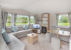 Living area - 12ft-wide stylish and comfortable caravan with one double and one twin. (Chapel St Leonards)