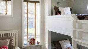 A child's bunk bed room with a window, a small table, and a toy house. - Lakeside 14 Casa Pet Friendly (Woodhall Spa)