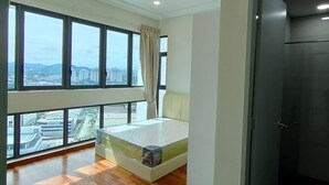 A bedroom with a large window, a bed, and a door leading to a bathroom. - Suasana Damai (Petaling Jaya)