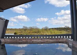 A hot tub with a view of a natural landscape.