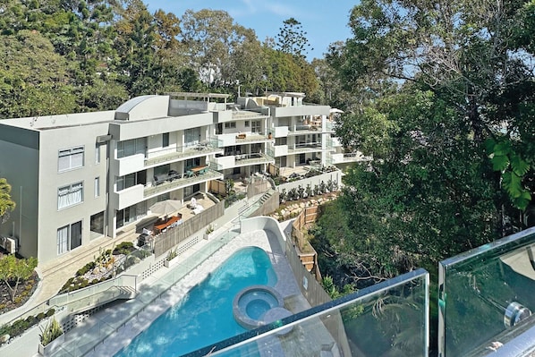 Enjoy a refreshing dip in the hotel's rooftop pool surrounded by lush greenery.