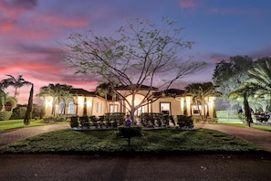 A hotel with a symmetrical facade, arched windows, and a central tree. - 8-BR with Pool & Mini-golf & Soccer (Davie)