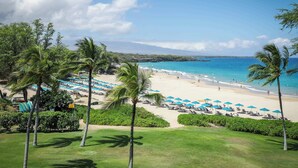 A beach resort with a clear view of the ocean, palm trees, and a well-maintained lawn. - Hapuna Beach Residences A34 Two Bedroom (Kamuela)