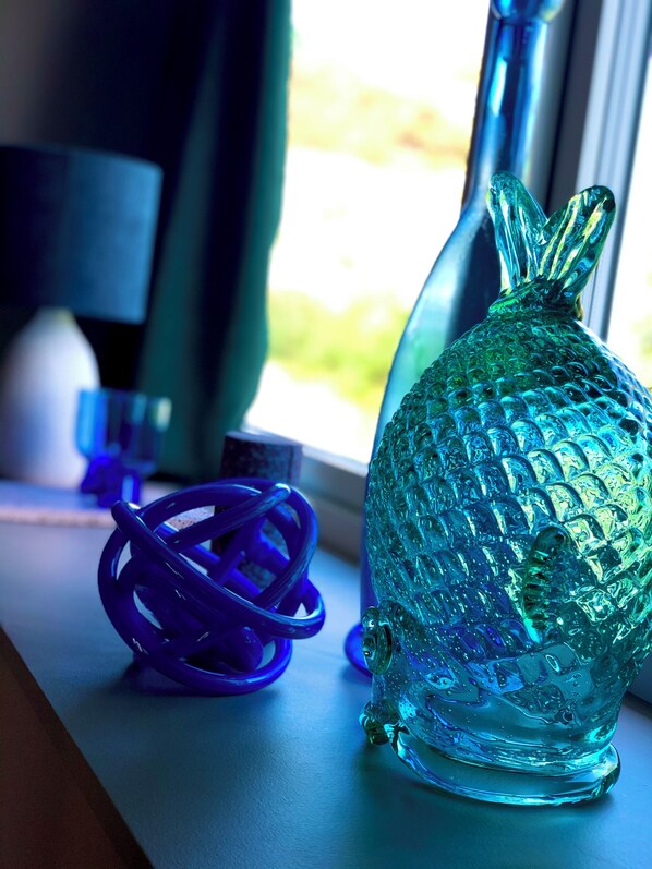 A glass sculpture on a windowsill.