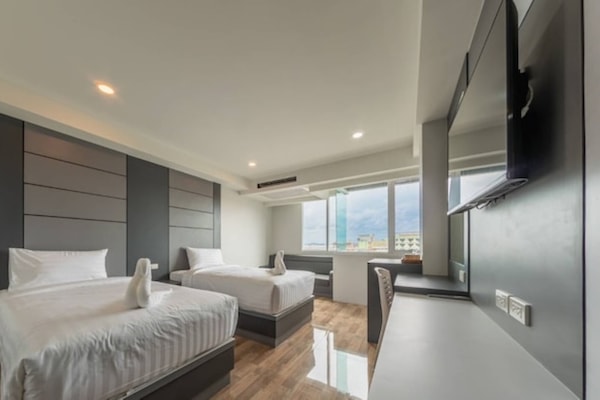 Superior Twin Room | Minibar, in-room safe, desk, iron/ironing board