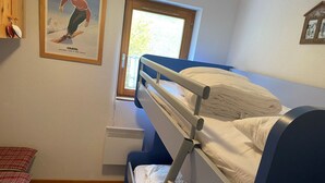 A bunk bed room with a window, a framed picture on the wall, and a small bench. - Bright apartment for 6 people with balcony and parking in Châtel (Châtel)