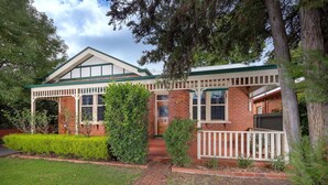 A two-story brick house with a green roof, white railings, and a small porch. - White Rabbit on Jones - Stunning three bedroom classic in the heart of Albury (Albury)