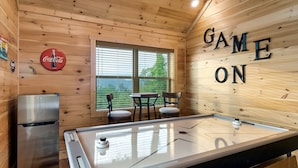 A wooden interior with a pool table, a refrigerator, and a Coca-Cola sign. - Prime Location! Relaxing 2/2 Luxury Cabin! Views, Fire Pit, Hot Tub & Game Room. (Gatlinburg)