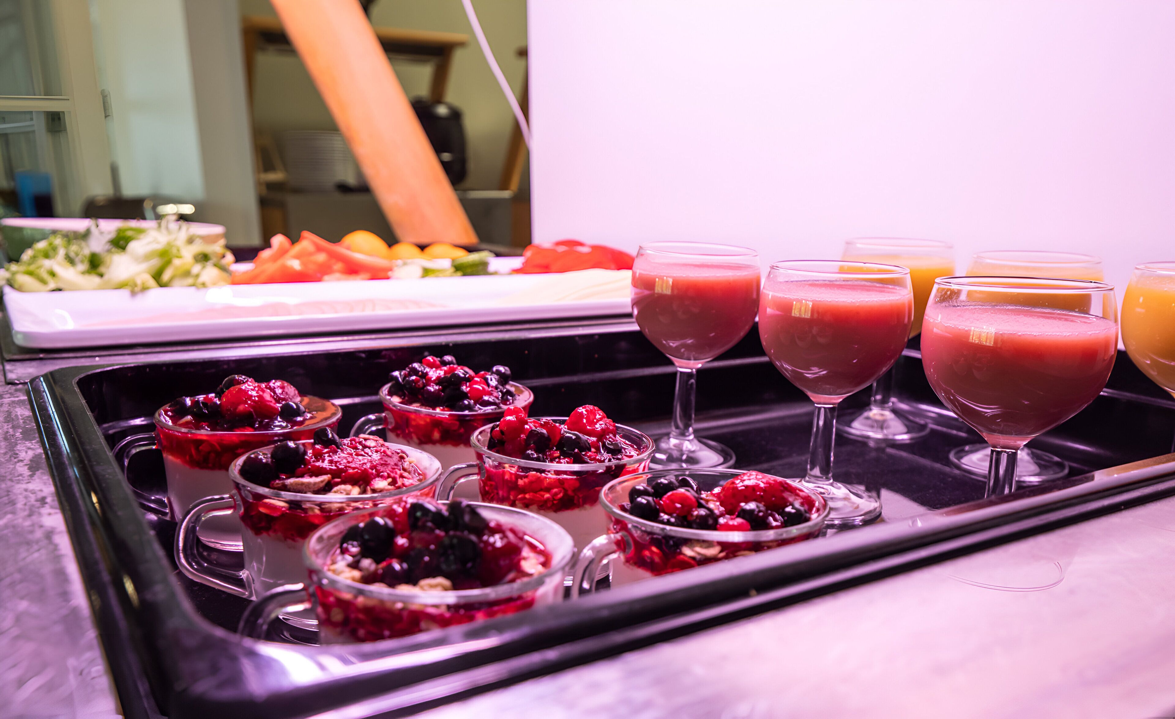 A buffet table with various food items and drinks.