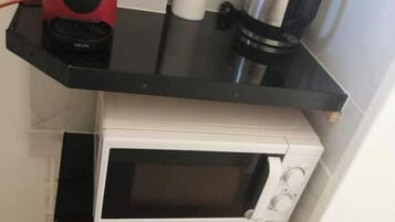 Fridge, stovetop, electric kettle, dining tables